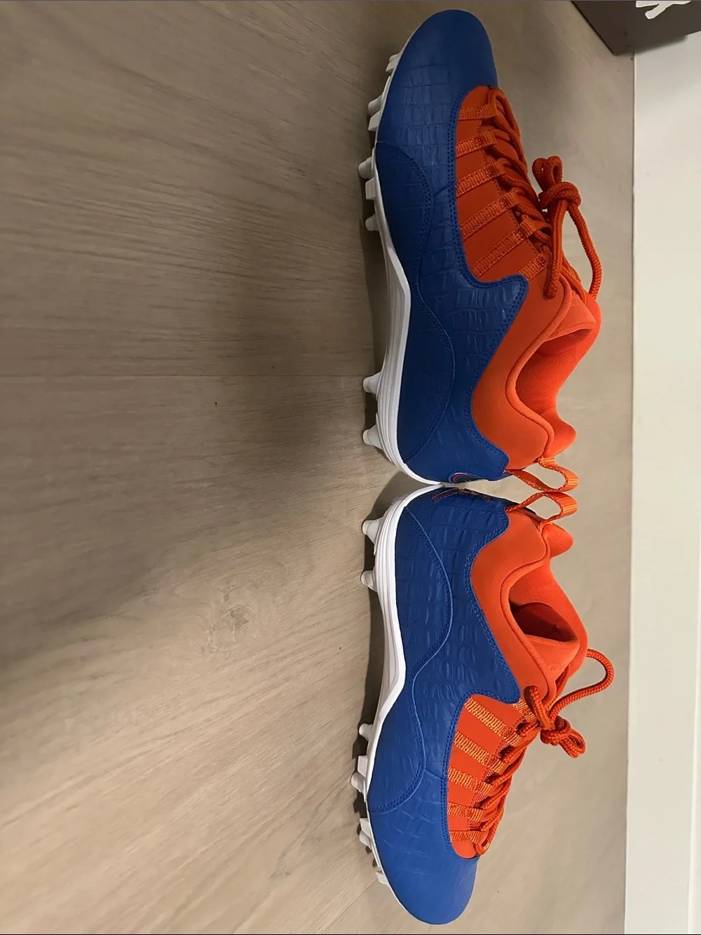 Custom Florida Air Jordan Cleats in Orange and Blue.